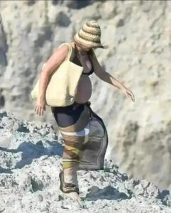 Margot Robbie showcasing her baby bump while on vacation in Italy last year with her husband Tom Ackerley..full detail