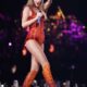 Watch as Taylor Swift sings “That’s My Man” in Paris and points specifically at Travis Kelce, getting a cute response in the process